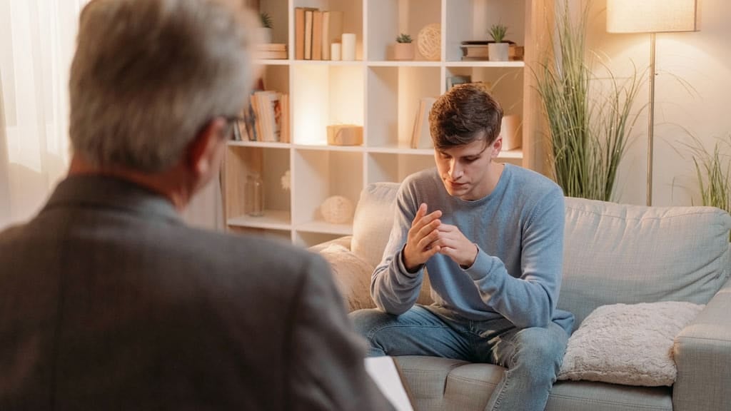 A depressed man in a therapist’s office
